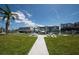 Picture of a maintained dock with seating, boat lifts, and building views at 171 Medallion Blvd # F, Madeira Beach, FL 33708