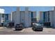 A lovely condo with multiple balconies and staircase with blue metal railings at 171 Medallion Blvd # F, Madeira Beach, FL 33708