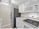 A kitchen showcasing white appliances and cabinets at 171 Medallion Blvd # F, Madeira Beach, FL 33708