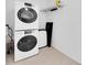 Laundry room featuring stackable washer and dryer and storage shelving for convenience at 171 Medallion Blvd # F, Madeira Beach, FL 33708
