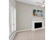 Bright living room features neutral walls, tile flooring, and a decorative fireplace at 171 Medallion Blvd # F, Madeira Beach, FL 33708