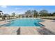 Community pool with outdoor lounge chairs and umbrellas and outdoor pavilion with ceiling fans at 17921 Nadine Pl, Nokomis, FL 34275