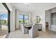 Dining room with large window, modern light fixture, and sliding doors to outdoor area at 17921 Nadine Pl, Nokomis, FL 34275