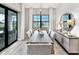 Dining room with large windows, modern light fixture, and access to outdoor patio at 17921 Nadine Pl, Nokomis, FL 34275
