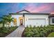 Beautiful single-story home with a two-car garage and a well-manicured front yard and landscaping at 17921 Nadine Pl, Nokomis, FL 34275