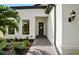 Inviting front entrance with a beautifully landscaped walkway leading to the decorative front door at 17921 Nadine Pl, Nokomis, FL 34275