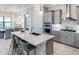 Open-concept kitchen with a large island, stainless steel appliances, and bar stool seating at 17921 Nadine Pl, Nokomis, FL 34275
