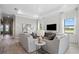 Bright living room with shiplap accent wall, tray ceiling, and comfortable seating arrangement at 17921 Nadine Pl, Nokomis, FL 34275
