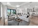 Open-concept living room featuring modern furnishings and an adjacent kitchen, perfect for entertaining at 17921 Nadine Pl, Nokomis, FL 34275