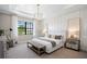 Serene main bedroom featuring a tray ceiling, large window, and elegant decor at 17921 Nadine Pl, Nokomis, FL 34275
