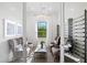Bright and airy sitting room features elegant decor, comfortable seating, and natural light at 17921 Nadine Pl, Nokomis, FL 34275
