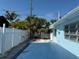 Private backyard is fenced in and also has palm trees offering shade at 195 45Th Ave, St Pete Beach, FL 33706