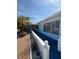 Exterior of the house featuring a blue exterior paint job, decorative white fence and gravel landscaping at 195 45Th Ave, St Pete Beach, FL 33706