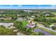 Aerial view of property, showcasing its prime location with lush green surroundings and nearby lake at 19810 Prince Benjamin Dr, Lutz, FL 33549
