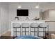 Stylish bar area featuring a white counter, sink, and four modern bar stools with pendant lighting at 19810 Prince Benjamin Dr, Lutz, FL 33549
