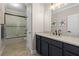 Bathroom featuring dark vanity, shower over tub and modern finishes at 19810 Prince Benjamin Dr, Lutz, FL 33549
