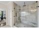 Modern bathroom featuring glass shower with tile surround and multiple shower heads at 19810 Prince Benjamin Dr, Lutz, FL 33549