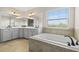 This bright bathroom features double sinks, stylish fixtures, and a luxurious soaking tub at 19810 Prince Benjamin Dr, Lutz, FL 33549