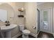 Elegant bathroom with a pedestal sink, a walk-in shower, and access to the outdoors at 19810 Prince Benjamin Dr, Lutz, FL 33549