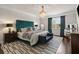 Luxurious bedroom with a green headboard, chandelier, and large window that let's in an abundance of light at 19810 Prince Benjamin Dr, Lutz, FL 33549