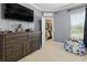 Bedroom with a walk-in closet and TV, offering ample space and storage at 19810 Prince Benjamin Dr, Lutz, FL 33549