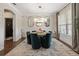 Elegant dining room featuring a round table, plush chairs, and a modern chandelier at 19810 Prince Benjamin Dr, Lutz, FL 33549