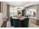 Bright dining room with round table, comfortable seating, and view into the living room at 19810 Prince Benjamin Dr, Lutz, FL 33549