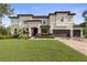 Two-story home boasts a three-car garage, well-manicured lawn, and a charming neutral-tone exterior at 19810 Prince Benjamin Dr, Lutz, FL 33549