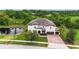 Beautiful single-Gathering home with a three-car garage, mature landscaping, and a view of the pond at 19810 Prince Benjamin Dr, Lutz, FL 33549