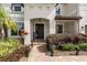 Charming front entrance with beautiful landscaping, a brick walkway, and a welcoming home sign at 19810 Prince Benjamin Dr, Lutz, FL 33549