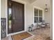 Inviting front porch with comfortable seating, elegant lighting, and a stylish welcome mat at 19810 Prince Benjamin Dr, Lutz, FL 33549