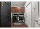 Well-organized laundry room with dark wood cabinets and modern washer and dryer at 19810 Prince Benjamin Dr, Lutz, FL 33549