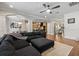 Open-concept living room featuring a large sectional sofa and views of the kitchen and dining area at 19810 Prince Benjamin Dr, Lutz, FL 33549
