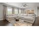 Bright living room with a large sectional sofa, modern decor, and backyard views at 19810 Prince Benjamin Dr, Lutz, FL 33549
