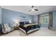 Comfortable main bedroom featuring a ceiling fan, soft lighting, and a serene atmosphere at 19810 Prince Benjamin Dr, Lutz, FL 33549
