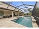 Beautiful pool and spa, with lots of outdoor space for eating and lounging, are surrounded by a screened enclosure at 19810 Prince Benjamin Dr, Lutz, FL 33549