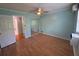 Bright bedroom with light blue walls, wood floors, a ceiling fan, and a closet with mirrored doors at 2077 Canal Dr # L35, Bradenton, FL 34207