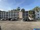 A three-story building with parking offers convenient access to units with balconies and well-maintained landscaping at 2077 Canal Dr # L35, Bradenton, FL 34207