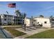 Community area with an American flag, picnic tables, landscaping, and a building in the background at 2077 Canal Dr # L35, Bradenton, FL 34207