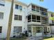 Exterior view of the building featuring screened-in patios and well maintained landscaping at 2077 Canal Dr # L35, Bradenton, FL 34207