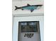 A front door with decorative metal shark sculpture shows curb appeal and a welcoming entrance at 2077 Canal Dr # L35, Bradenton, FL 34207