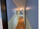 Hallway with hardwood floors, a closet with mirrored doors, and access to other rooms at 2077 Canal Dr # L35, Bradenton, FL 34207