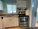 Kitchen featuring stainless steel appliances, white cabinets, and a large window with blinds at 2077 Canal Dr # L35, Bradenton, FL 34207