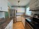 Kitchen with stainless steel appliances, white cabinets, and a stainless steel double-door refrigerator at 2077 Canal Dr # L35, Bradenton, FL 34207