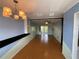 Bright living room features wood floors, modern lighting, and access to the outdoor patio at 2077 Canal Dr # L35, Bradenton, FL 34207
