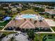 A high angle shot of the clubhouse with pool, volleyball court, and beautiful landscaping at 2344 Pleasant Hill Ln, Holiday, FL 34691