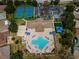 Aerial view of a community center featuring a pool, tennis courts, and sand volleyball at 2344 Pleasant Hill Ln, Holiday, FL 34691