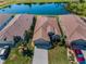 A bird's eye view of a home with its spacious driveway, backyard, and surrounding community at 2344 Pleasant Hill Ln, Holiday, FL 34691