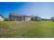 Spacious backyard with screened-in patios and lush green lawn at 2344 Pleasant Hill Ln, Holiday, FL 34691