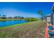 Beautiful backyard view overlooking a serene lake with lush greenery and screened lanai at 2344 Pleasant Hill Ln, Holiday, FL 34691